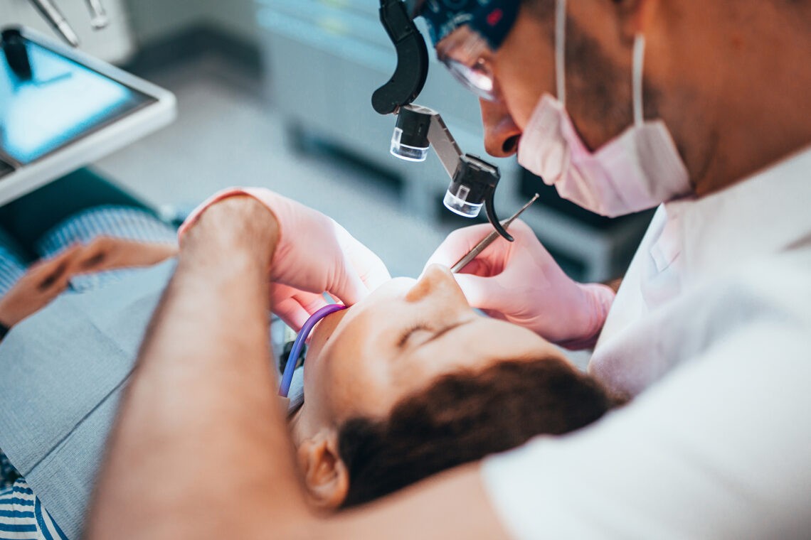 Na czym polega i kiedy stosowana jest endodoncja?; na zdjęciu pacjent podczas wizyty u dentysty- Hello Zdrowie