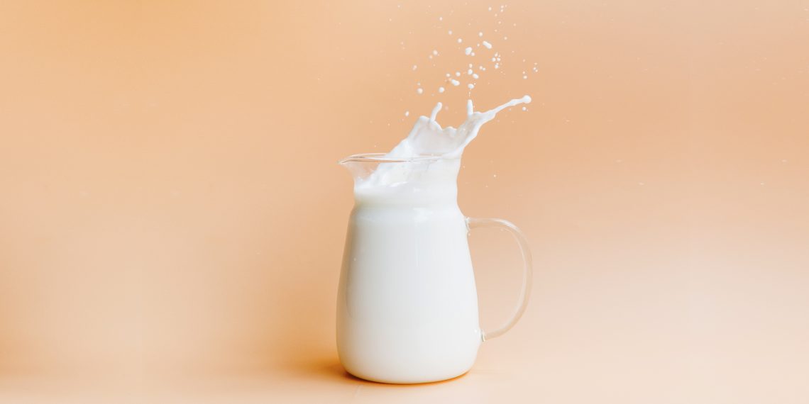 Tekst o zaletach i wadach picia mleka. Na zdjęciu: Dzbanek z mlekiem ze szczyptą mleka - HelloZdrowie