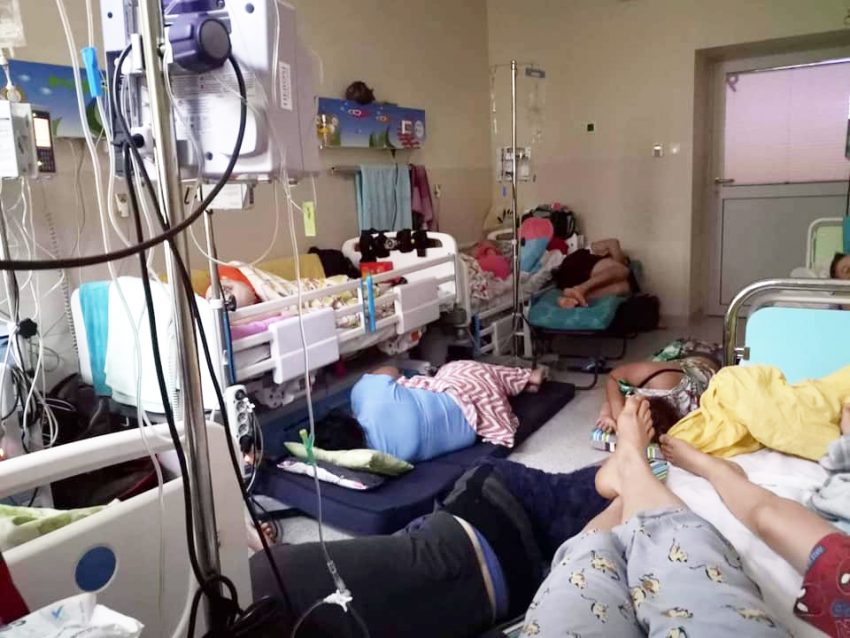 Sala na onkologii dziecięcej. Rodzice w małym pomieszczeniu śpią na podłodze, czuwając przy chorych dzieciach