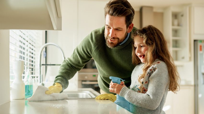 Córka z ojcem sprzątają blat kuchenny