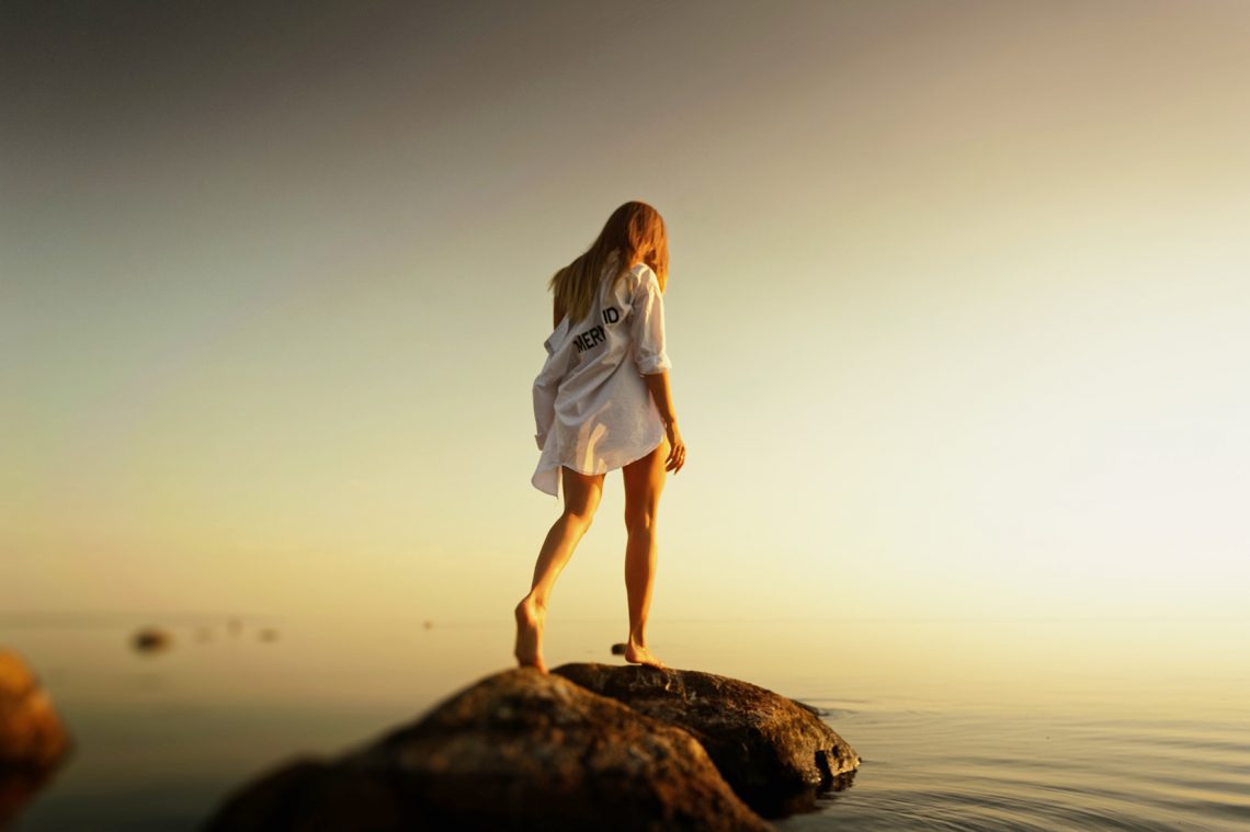 Dziewczyna stoi nad brzegiem morza